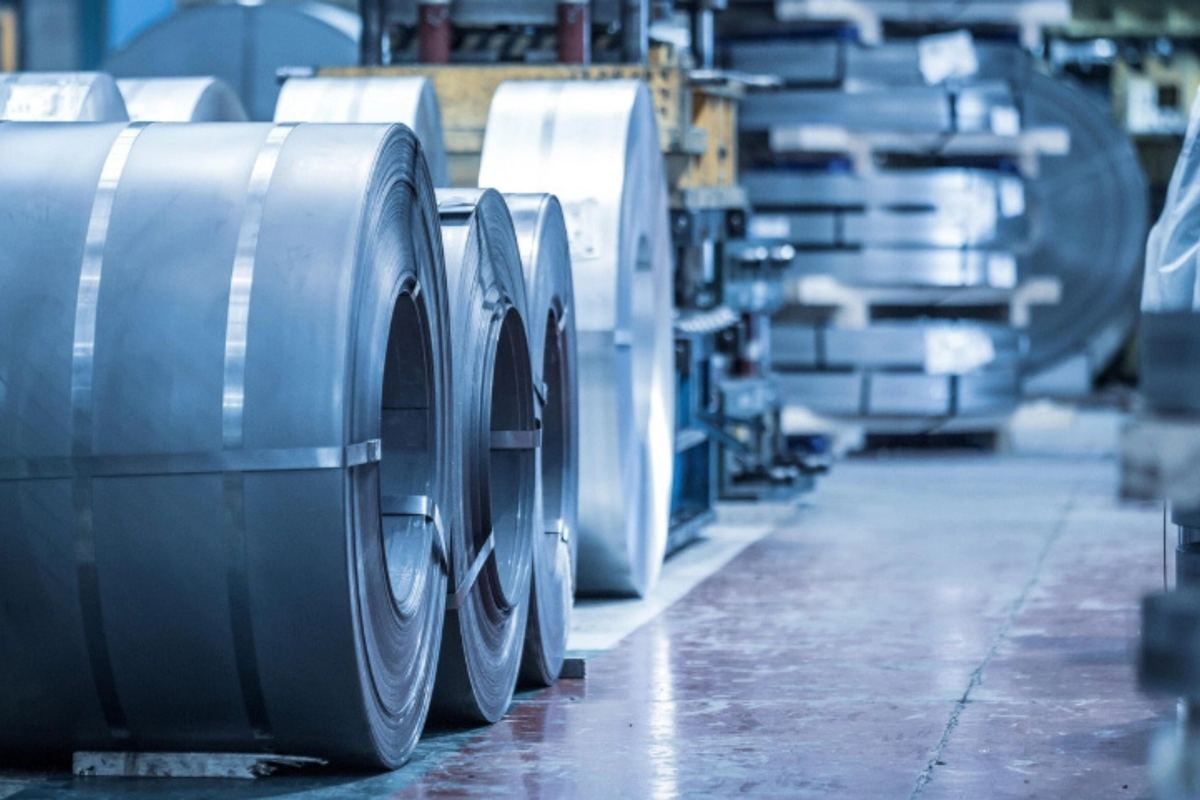 Rolled steel coils stacked in an industrial warehouse, representing Laplasco's premium raw materials supply